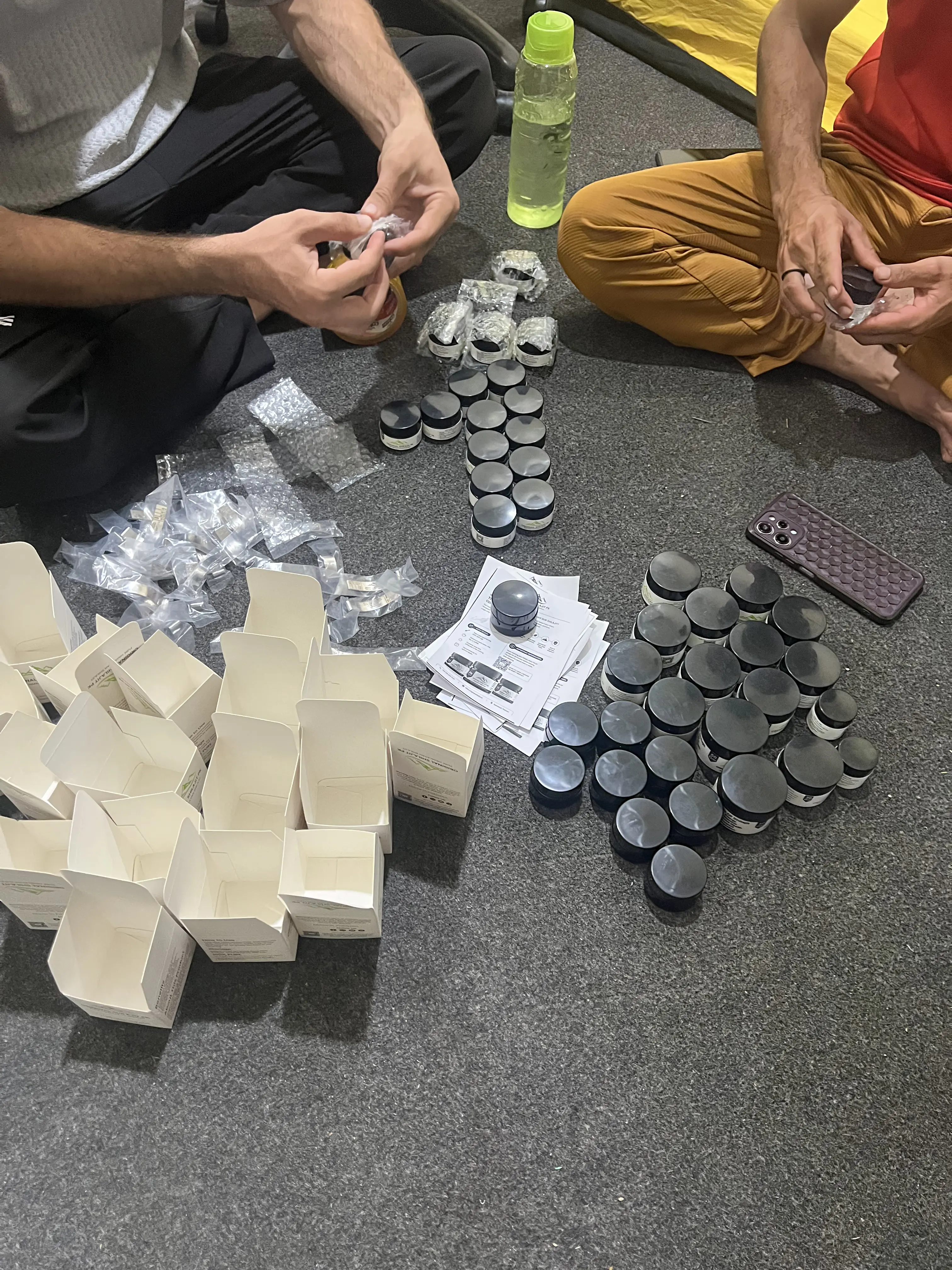 Original Shilajit PK team wrapping jars in bubble wrap and preparing boxes