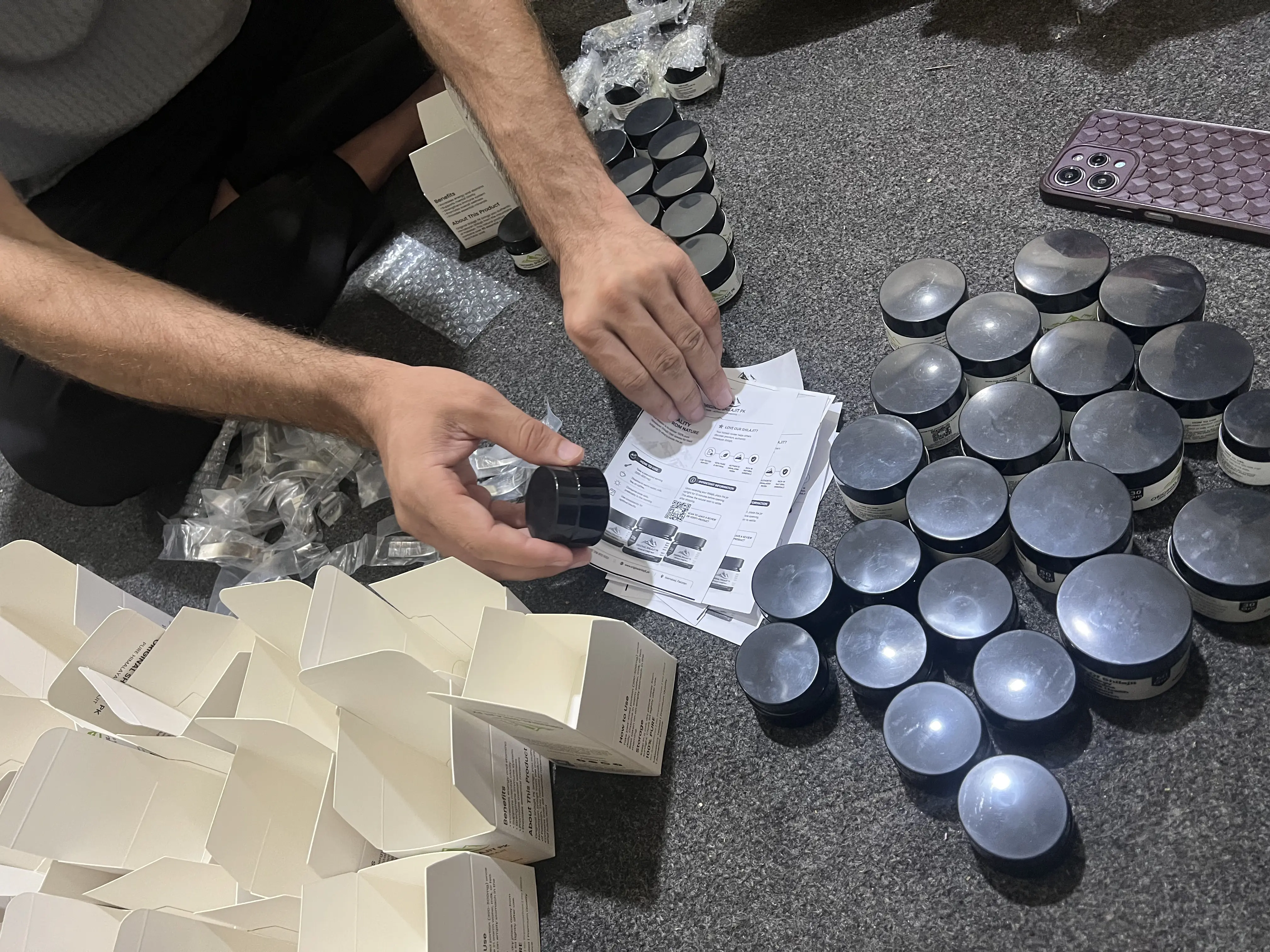 Original Shilajit PK jar placed on the printed usage guide that goes in every box